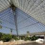 Event pyramid, © Eventhotel Pyramide GmbH Interior view of a large glass pyramid with plants and palm trees.