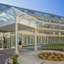 Inner courtyard, © Badener KurbetriebsgesmbH/Ulz Modern building entrance with glass roof and garden.