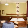 Second bed room, © Schwertfuehrer Christian Hotel room with double bed, sofa, table and TV.