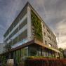 Modern hotel building with vertical garden wall and glass façade.