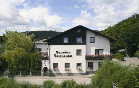 A two-storey building with the inscription 'Pension Seelenental', surrounded by trees and bushes.