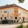 A yellow two-story building with the inscription 'Gasthof Pension G. Martinek'.