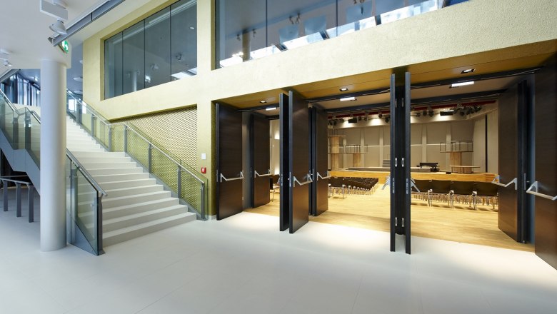Modern interior with staircase and open hall.