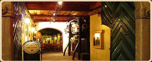 Entrance area of a rustic building with wooden doors and decorations.
