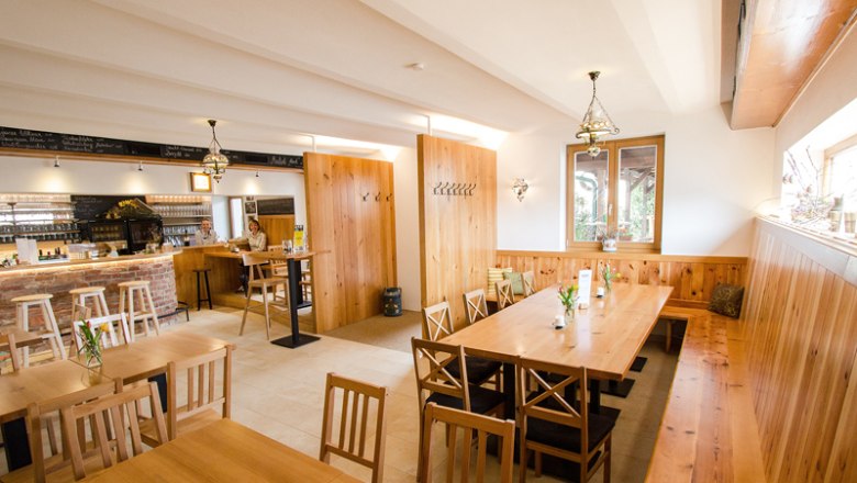 Cozy dining room with wooden furniture and bar.