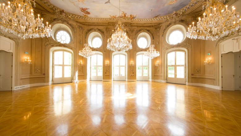Elegant ballroom with chandeliers and painted ceiling at the Conference Center Laxenburg.